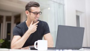 man with coffee and laptop